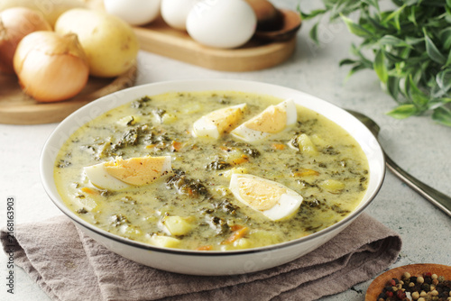 A bowl with traditional Polish sorrel soup Zupa Szczawiowa	