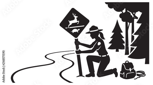 Bild auf Leinwand Park ranger installing a wildlife crossing sign is depicted in silhouette
