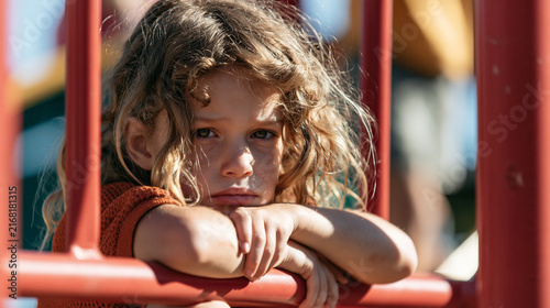 Sad child on the playground.