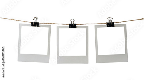 Three blank instant photo frames hanging on a rope isolated on transparent background