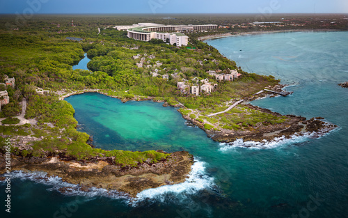 Aerial view of luxury resort and stunning cliff overlooking the turquoise Caribbean Sea.Summer vacation and travel destination. Playa del Carmen, Riviera Maya, Mexico.
