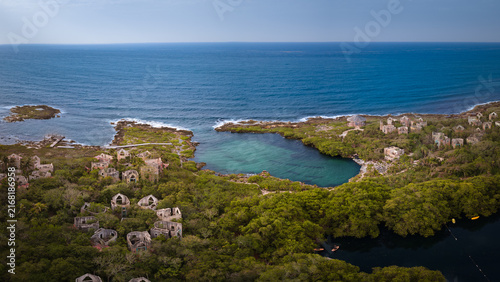 Panorama of beach with a stunning cliff overlooking the Caribbean Sea, luxury resort and palm trees surrounded.Summer concept, Playa del Carmen, Riviera Maya, Mexico.