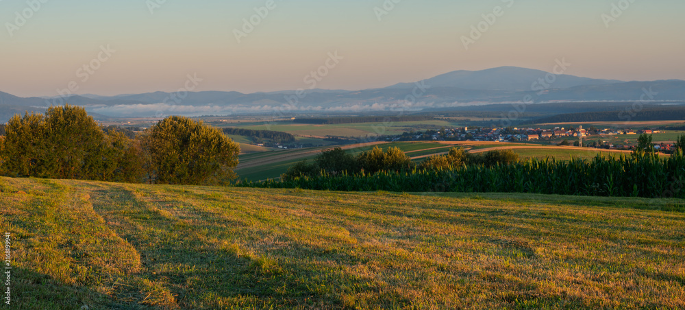 Fototapeta premium A mountain meadow after haymaking