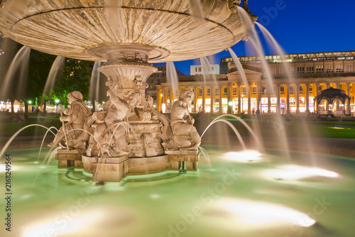 An illuminated fountain flows at Schlossplatz square in Stuttgart