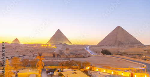 Great Sphinx and Pyramid of Khafre at dusk under artificial spotlighting on the Giza plateau