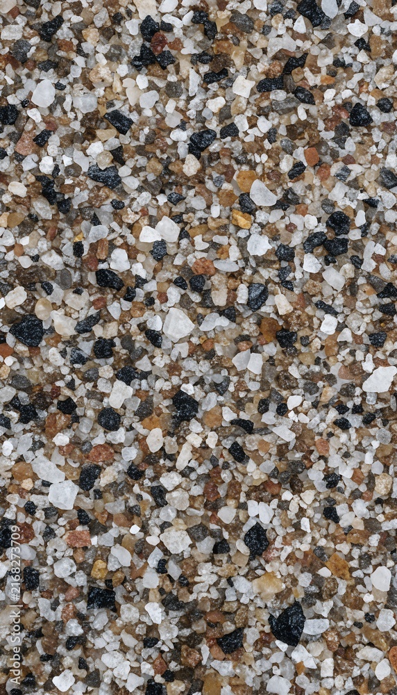 Fototapeta premium Top view macro crushed quartz sand grains with black basalt and brown mineral pebbles texture background vertical mobile wallpaper illustration