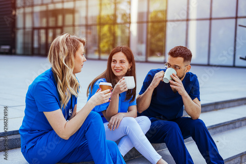 Fotografía Healthcare Workers Taking a Coffee Break Outside Hospital Smiling Medical Staff