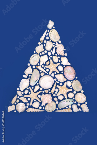 Tree shape design with seashells and oyster pearls on blue background. Seasonal seaside art decoration concept. Greeting card. 