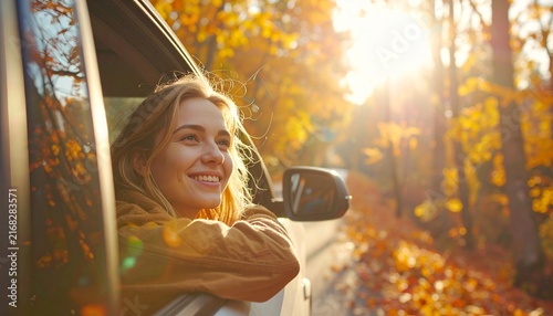 Portrait of Smiling Woman in Car with Blurry Fall Foliage Background