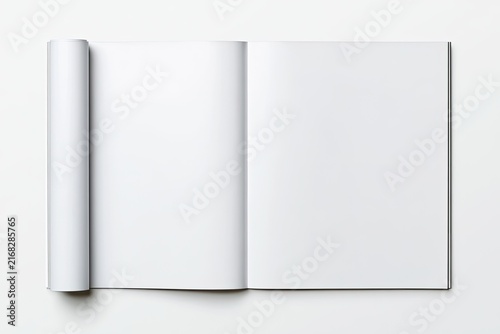 Opened blank white magazine with a rolled-up left page on a white surface