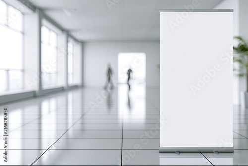 White banner stand in modern office lobby with blurred figures