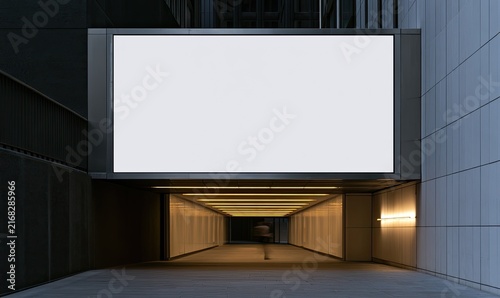 Large blank digital screen above a dimly lit tunnel with a blurred figure