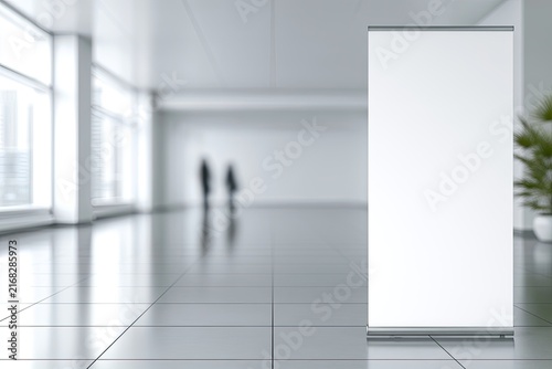White banner stand in empty, modern lobby with blurred figures
