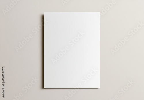 Blank white rectangular card, upright, casting subtle shadow on muted background