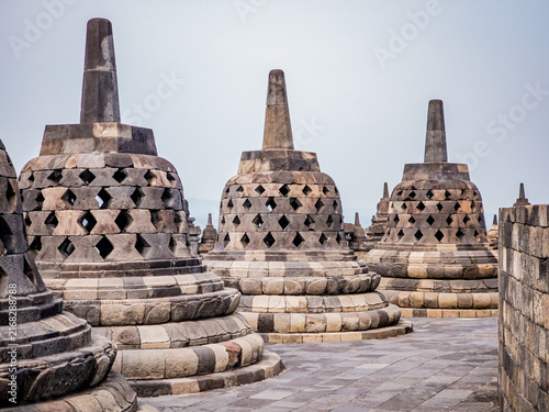 Canvas Print Ancient stone stupas with geometric patterns on the Borobudur temple complex, sh