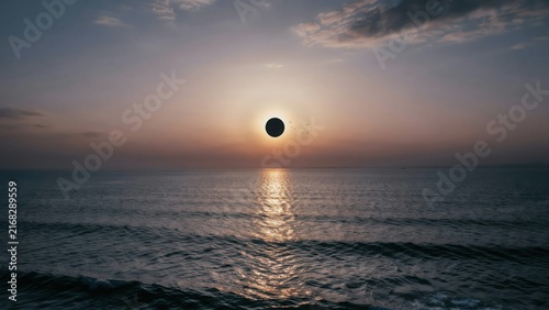 Dramatic sunset over calm ocean with silhouetted horizon, cinematic atmosphere dramatic sky