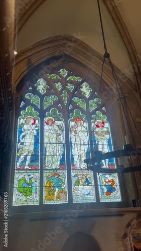 Medieval stained glass windows and mosaics inside the dining hall of Christ Church College. Concept of academic heritage and historic university interiors