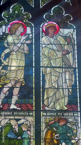 Medieval stained glass windows and mosaics inside the dining hall of Christ Church College. Concept of academic heritage and historic university interiors