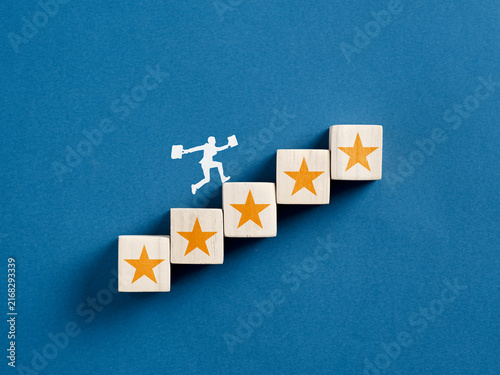 Foto Businessman climbing wooden blocks with stars reaching success