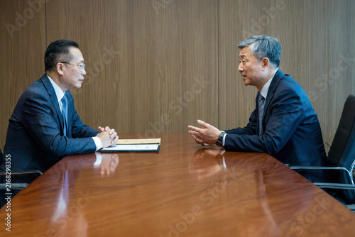 Two Executives Discussing AI Data Governance in a Conference Room