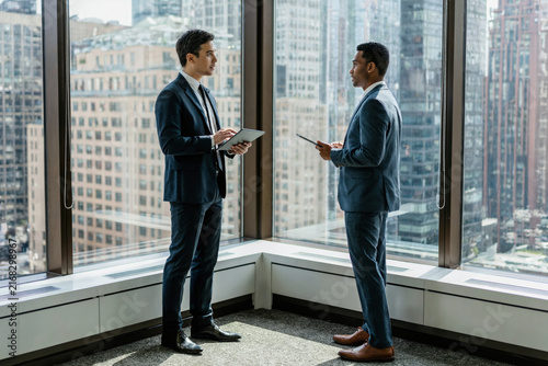 Two Executives Discussing Strategy in a Modern Corner Office