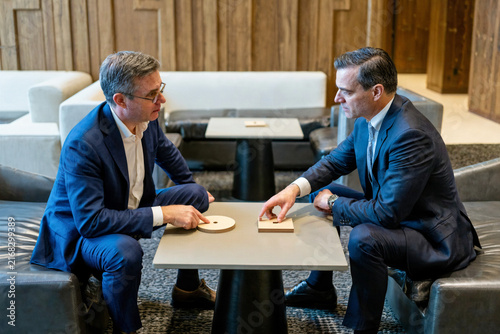 Corporate Executives Negotiating Strategy in a Modern Lounge