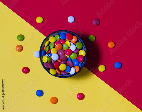 Canvas Print Top view of colorful chocolate candies on a colorful background