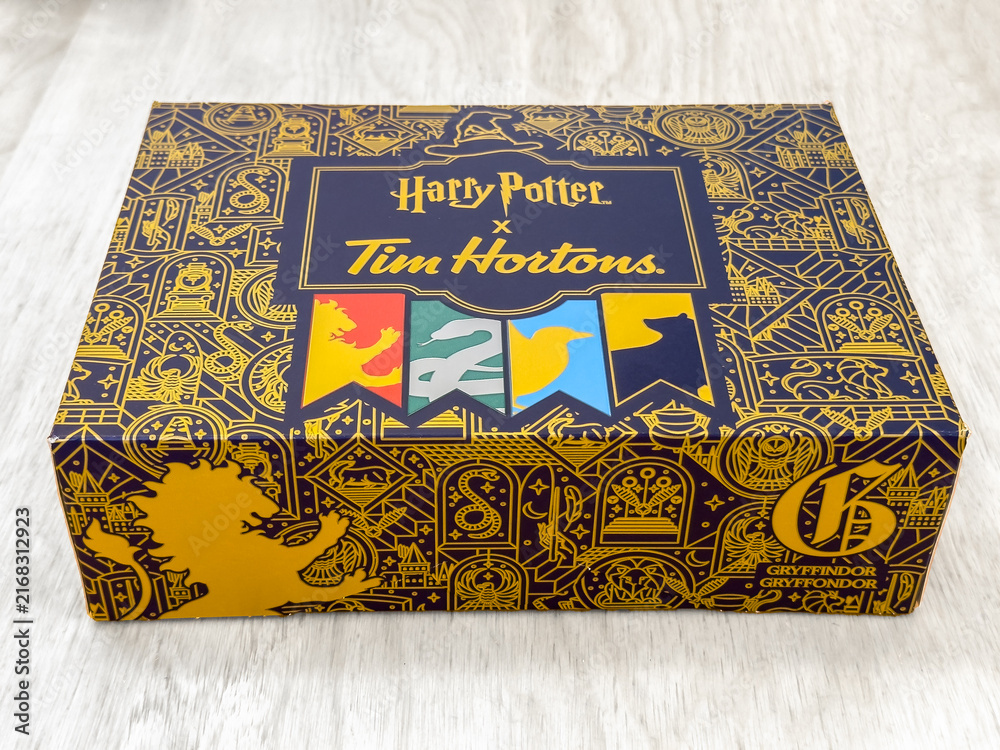 Naklejka premium Toronto, Ontario, Canada. August 12, 2026. Angled close-up of a limited-edition Harry Potter x Tim Hortons donut box on a light surface.