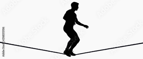 Silhouette of Man Balancing on Tightrope Against White Background