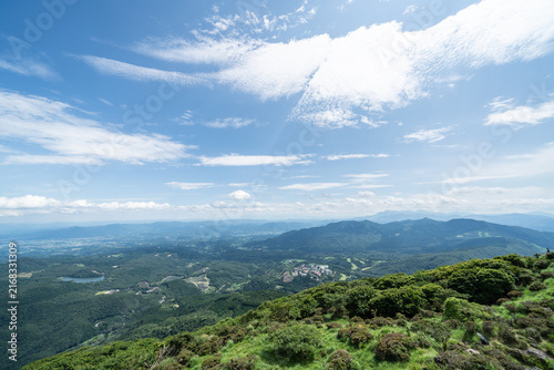Fotografie Panoramic aerial view of Beppu city and Beppu bay under blue sky with clouds fro