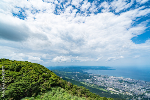 Foto Panoramic aerial view of Beppu city and Beppu bay under blue sky with clouds fro
