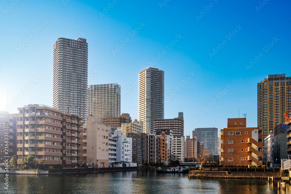 Naklejka premium 運河の水面に映る高層マンション群と青空の美しい景観