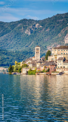 Panoramic view of San Giulio Island on Lake Orta, Piedmont, Italy, featuring the historic basilica and picturesque lakeside scenery surrounded by Alpine landscapes