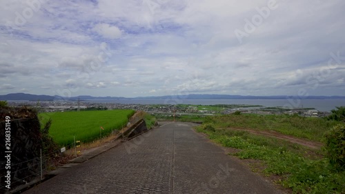 Walking Down Mountain Road Overlooking Omura City, Rice Fields and Bay in Nagasaki, Japan