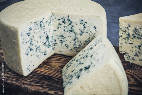 Cheese collection, piece of gorgonzola cheese on wooden background