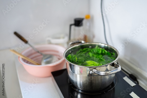 Canvastavla Mustard greens blanching in the pot