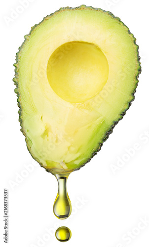  A half of a ripe avocado with a drop of natural oil, isolated on a white background. Essential superfood image.