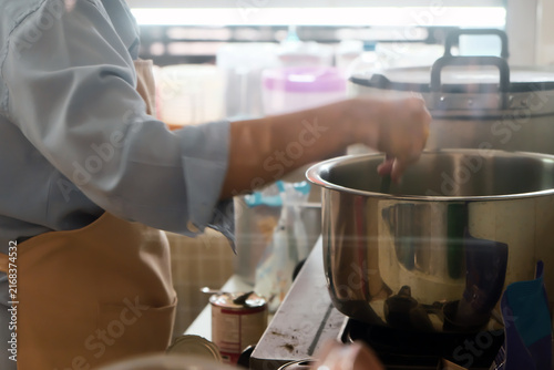 Close up Image of Woman preparing food at the stove