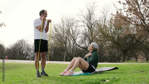Happy mature couple doing exercises together in a public park