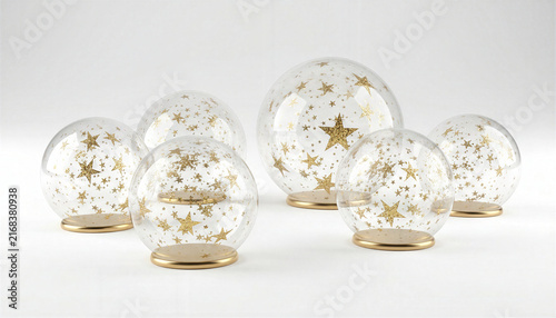 Decorative clear glass spheres with gold star patterns on gold stands