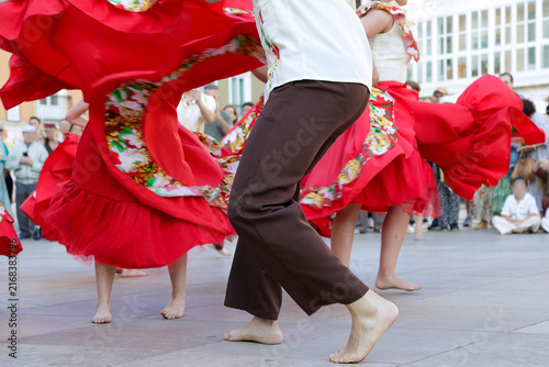 Dancers performing and wearing traditional folk costumes from Chile