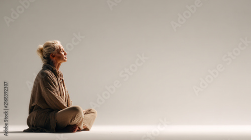 person in meditative pose exudes tranquility against ultrabright clean background