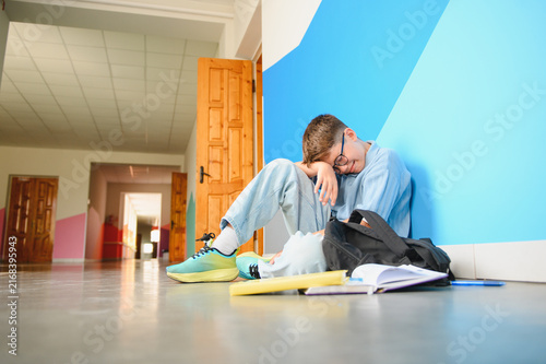 Foto Sad boy crying alone feeling bullied at school