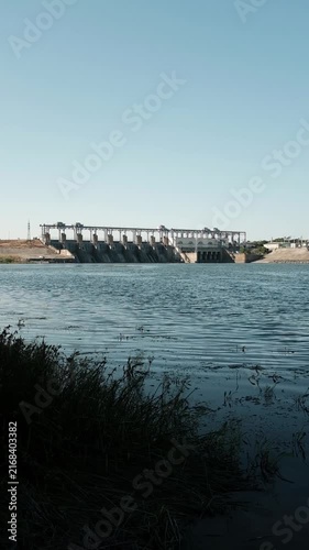 Hydroelectric power station and dam standing across a river. For documentaries on renewable energy,  presentations on clean power generation, environmental reports, or industrial infrastructure.