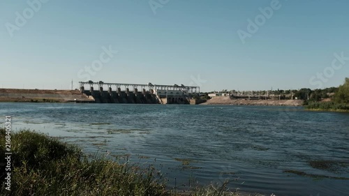 Hydroelectric power station and dam standing across a river. For documentaries on renewable energy,  presentations on clean power generation, environmental reports, or industrial infrastructure.