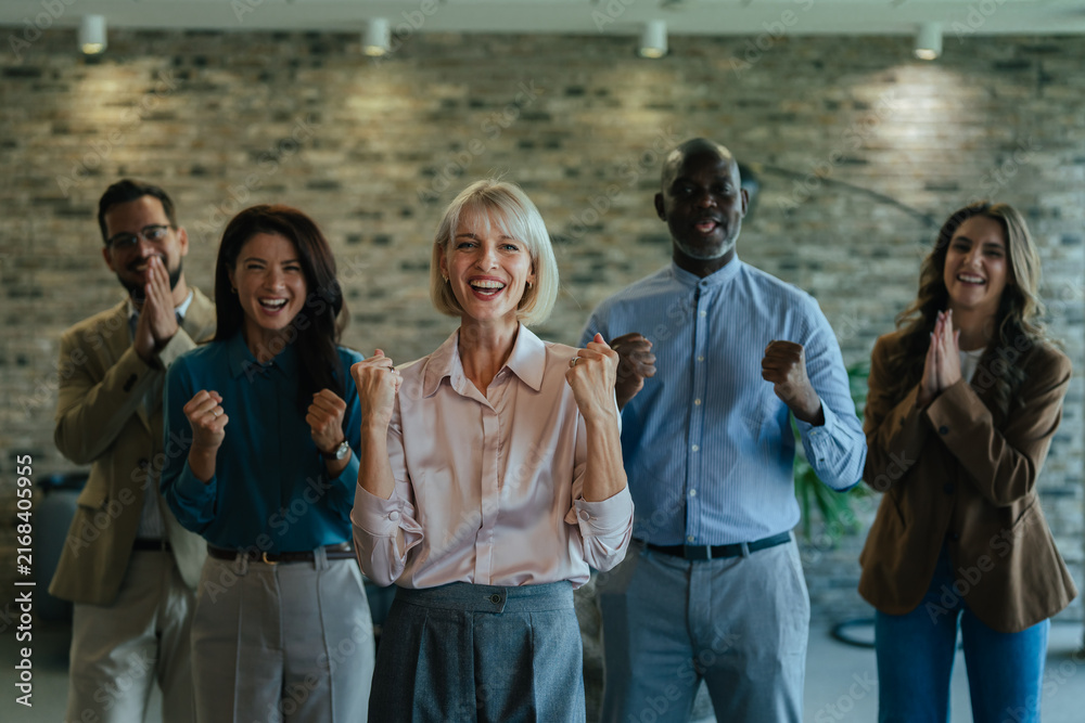 Fototapeta premium Diverse business team celebrating success and achievement in office
