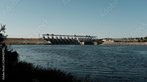 Hydroelectric power station and dam standing across a river. For documentaries on renewable energy,  presentations on clean power generation, environmental reports, or industrial infrastructure.