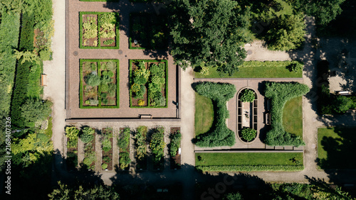 Top-down aerial view of geometric garden beds and hedges in a formal city garden, lithuania travel content, landscape architecture photography, botanical garden marketing, city guide imagery