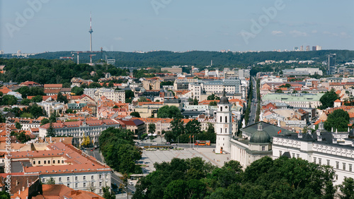 Aerial panorama of Vilnius old town with red rooftops, distant TV tower and soft haze, lithuania travel content, city tourism marketing, drone photography stock, heritage promotion imagery