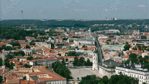 Aerial view of Vilnius old town with a curving road, red rooftops and the TV tower on the horizon, lithuania travel content, drone photography stock, city skyline marketing, tourism campaign imagery